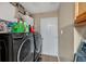 Laundry room featuring modern, black washer and dryer units and a white door at 161 Gann Cemetery Rd, Dallas, GA 30157