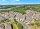 An aerial view captures the beauty of townhouses nestled in a vibrant community with stunning lake and forest views at 1610 Habersham Villa Dr, Cumming, GA 30041