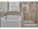Modern bathroom featuring a soaking tub, tiled shower, and natural light, offering a spa-like experience at 1610 Habersham Villa Dr, Cumming, GA 30041