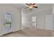 Spacious bedroom with a ceiling fan, a door leading to a balcony, and ample natural light at 1610 Habersham Villa Dr, Cumming, GA 30041