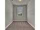 Bright bedroom with soft carpeting, a ceiling light, and a window offering natural illumination at 1610 Habersham Villa Dr, Cumming, GA 30041