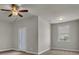 Cozy bedroom with neutral carpet, ceiling fan, and a bright window, offering a serene retreat at 1610 Habersham Villa Dr, Cumming, GA 30041