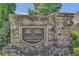 Stone entrance to the Villas at Habersham community with lush landscaping at 1610 Habersham Villa Dr, Cumming, GA 30041
