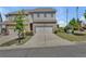 Two-story townhome showcasing a two-car garage and a well-maintained front yard and driveway at 1610 Habersham Villa Dr, Cumming, GA 30041