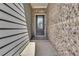 A charming front entrance features a gray door with brick accents, enhancing curb appeal at 1610 Habersham Villa Dr, Cumming, GA 30041