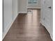 Hallway showcasing hardwood floors leading to an open living area with great light at 1610 Habersham Villa Dr, Cumming, GA 30041