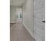 Hallway with neutral walls and carpet flooring, leading to French doors and a bright, open space at 1610 Habersham Villa Dr, Cumming, GA 30041