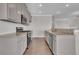 Modern kitchen featuring stainless steel appliances and granite countertops at 1610 Habersham Villa Dr, Cumming, GA 30041