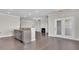 Open concept living room and kitchen with hardwood floors and a fireplace at 1610 Habersham Villa Dr, Cumming, GA 30041