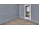Exterior door on a covered patio with wood flooring, enhancing indoor-outdoor living at 1610 Habersham Villa Dr, Cumming, GA 30041