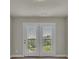 Bright room with double doors leading to a balcony, offering picturesque outdoor views at 1610 Habersham Villa Dr, Cumming, GA 30041
