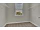 Bright walk-in closet featuring built-in wire shelving, neutral paint, and a window for natural light at 1610 Habersham Villa Dr, Cumming, GA 30041