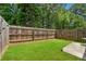 Fenced backyard with grassy area and concrete patio at 3040 Clear View Ln, Snellville, GA 30078