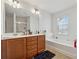 Bathroom with double sink vanity, separate tub and shower, and natural light at 3040 Clear View Ln, Snellville, GA 30078