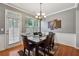 Chic dining area with a modern chandelier, a decorative rug, and a door to the outside, ideal for Gathering meals at 3040 Clear View Ln, Snellville, GA 30078