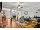 Bright living room with hardwood floors, a ceiling fan, and access to the dining area, offering a comfortable living space at 3040 Clear View Ln, Snellville, GA 30078