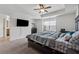 Spacious main bedroom featuring ceiling fan, tray ceilings and large window at 3040 Clear View Ln, Snellville, GA 30078