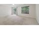 Spacious bedroom with neutral carpet, window and sliding glass door with outdoor views at 755 Magnolia Gardens Walk, Mcdonough, GA 30253