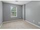 Clean, vacant bedroom with neutral carpet and walls, plus a bright window at 755 Magnolia Gardens Walk, Mcdonough, GA 30253