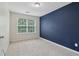 A well-lit bedroom featuring a large window and a striking accent wall for a bold, modern look at 755 Magnolia Gardens Walk, Mcdonough, GA 30253