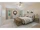 Beautifully staged bedroom with neutral tones, two windows, and matching bedside tables and lamps at 755 Magnolia Gardens Walk, Mcdonough, GA 30253