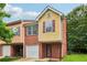Two-story brick and siding townhome with a one car garage and minimal landscaping at 755 Magnolia Gardens Walk, Mcdonough, GA 30253
