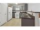 Efficient kitchen with gray cabinets, breakfast bar, and white appliances at 755 Magnolia Gardens Walk, Mcdonough, GA 30253
