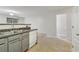 Functional kitchen featuring a stainless steel sink, white dishwasher, and view into the adjacent room at 755 Magnolia Gardens Walk, Mcdonough, GA 30253