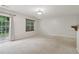 Neutral living room with carpet, a breakfast bar, and sliding glass door leading to the outside at 755 Magnolia Gardens Walk, Mcdonough, GA 30253