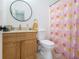 Bathroom featuring colorful shower curtain, vanity with a mirror and sink, and toilet at 93 Terry St # A, Atlanta, GA 30312