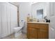 Bathroom with a toilet, white shower curtain, a mirror, and a vanity with storage at 93 Terry St # A, Atlanta, GA 30312