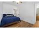 Cozy bedroom with hardwood floors, a ceiling fan, and a comfortable bed with decorative pillows at 93 Terry St # A, Atlanta, GA 30312