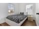 Bright bedroom with a modern bed, side table, and large windows offering natural light at 93 Terry St # A, Atlanta, GA 30312