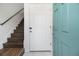 Welcoming entryway featuring stairs with railing, white door, and a pop of color with teal door at 93 Terry St # A, Atlanta, GA 30312