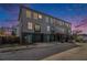 Three-story townhome with gray siding, black brick foundation, and brightly colored doors at 93 Terry St # A, Atlanta, GA 30312