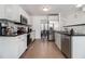 Bright kitchen with white cabinets, stainless steel appliances, and black countertops at 93 Terry St # A, Atlanta, GA 30312