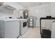 Functional laundry room with washer, dryer, shelving, and storage space for convenience at 93 Terry St # A, Atlanta, GA 30312