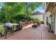 Wooden back deck features green space, grill, covered eating area, and cozy fire pit at 1775 Potomac Ct, Lawrenceville, GA 30043
