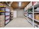 Basement with ample storage, shelving, and exposed wooden ceiling beams at 1775 Potomac Ct, Lawrenceville, GA 30043