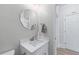 Bathroom featuring white vanity and countertop, octagonal mirror, and modern fixtures at 1775 Potomac Ct, Lawrenceville, GA 30043