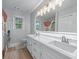 Bathroom features double sinks, neutral paint, shower with glass door, and modern lighting at 1775 Potomac Ct, Lawrenceville, GA 30043