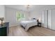 Bedroom featuring neutral paint, hardwood floors, and large windows at 1775 Potomac Ct, Lawrenceville, GA 30043