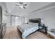 Bedroom features neutral paint, hardwood floors, tray ceiling, en suite bathroom, and modern decor at 1775 Potomac Ct, Lawrenceville, GA 30043