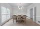 Elegant dining room with modern chandelier, hardwood floors, and large windows at 1775 Potomac Ct, Lawrenceville, GA 30043