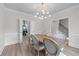 Open dining room adjacent to the kitchen area, featuring a modern chandelier at 1775 Potomac Ct, Lawrenceville, GA 30043