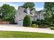 Charming two-story home showing side view and two-car garage, complemented by lush greenery at 1775 Potomac Ct, Lawrenceville, GA 30043