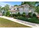 Beautiful two-story home with mature landscaping, dormer windows, and light-colored facade at 1775 Potomac Ct, Lawrenceville, GA 30043