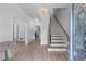 Inviting foyer with hardwood floors, a chandelier, staircase, and view of the kitchen at 1775 Potomac Ct, Lawrenceville, GA 30043
