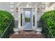 Elegant front door with decorative glass and brick steps, flanked by potted plants at 1775 Potomac Ct, Lawrenceville, GA 30043