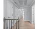 Upstairs hallway featuring neutral walls, wood flooring, and several doors leading to rooms at 1775 Potomac Ct, Lawrenceville, GA 30043